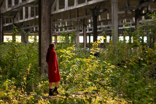 Female model being photographed with grunge environment during urban exploration