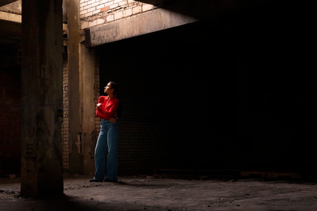 Female model being photographed with grunge environment during urban exploration