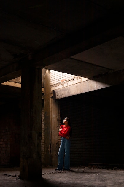 Female model being photographed with grunge environment during urban exploration