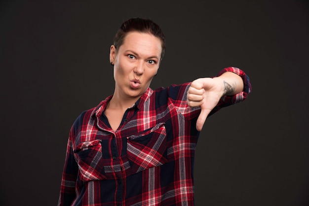 Female model in fall winter collection outfits making thumb down.