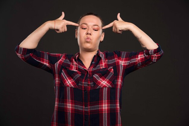 Female model in fall winter collection outfits pointing her head. 