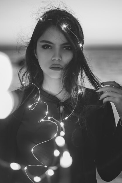 Female model posing with decorative light bulbs