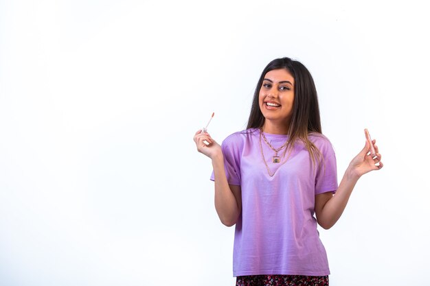 Female model promoting lip products and having fun. 