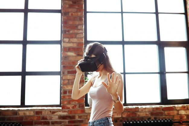 Female model watching videos in virtual reality glasses