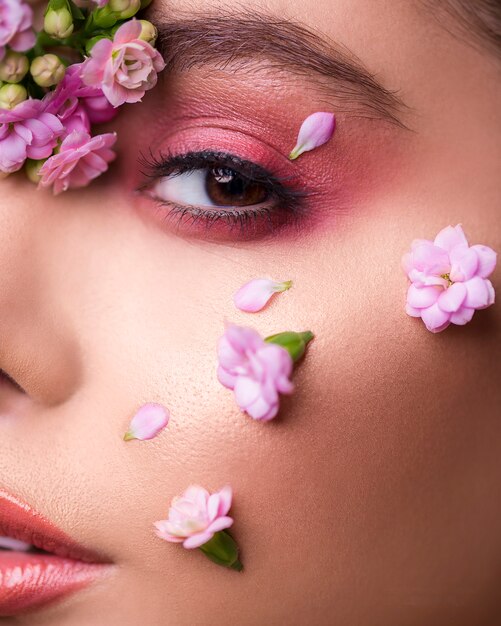 Female model with flowers in her face