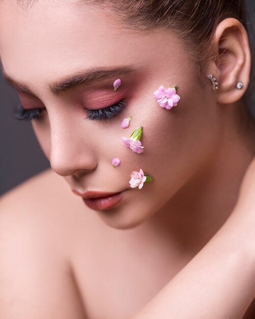 Female model with flowers in her face
