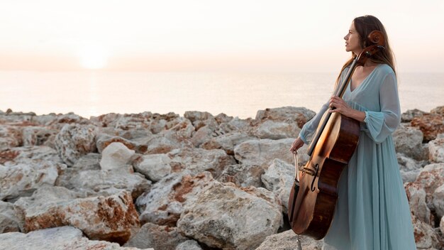 Female musician with cello and copy space