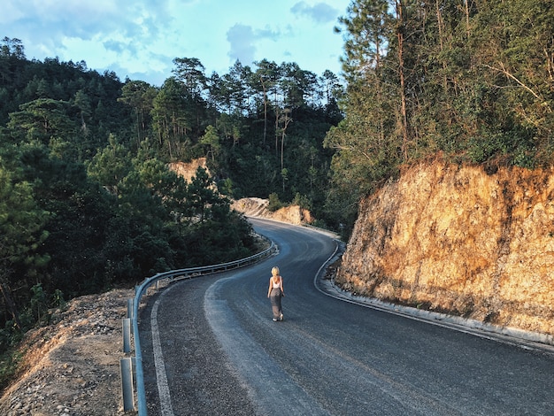 A female on a narrow curvy road