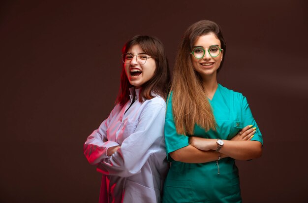 Female nurse and doctor look professional and smiling.