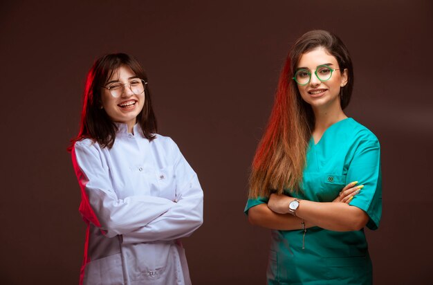 Female nurse and doctor look professional and smiling. 