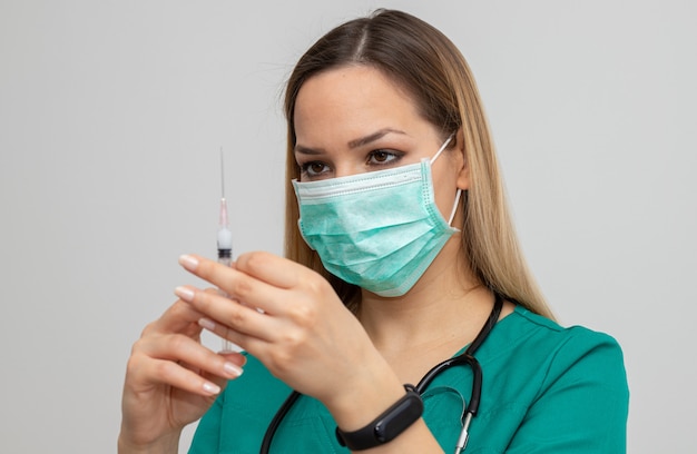 Female nurse holding syringe with injection
