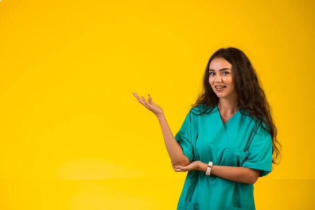 Female nurse opens hands and looks happy