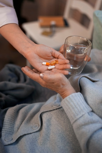 Female nurse taking care of elderly person