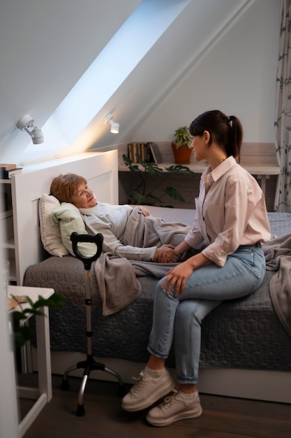 Female nurse taking care of elderly person