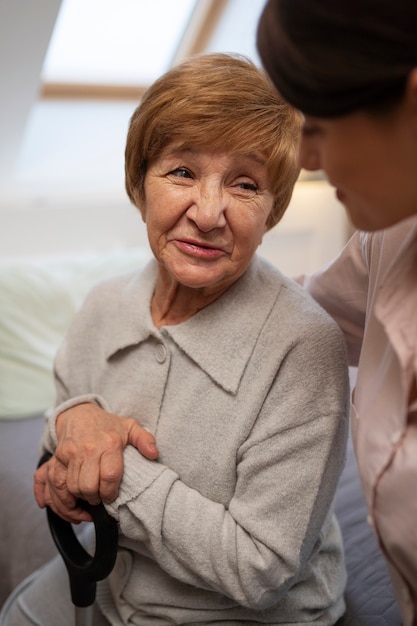 Female nurse taking care of elderly person