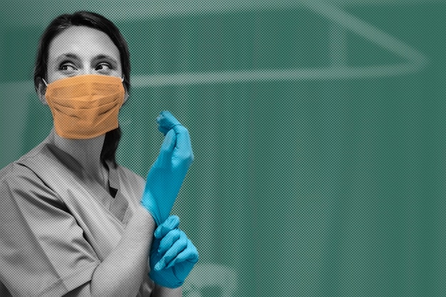 Free photo female nurse with a mask putting on gloves preparing to cure coronavirus patient