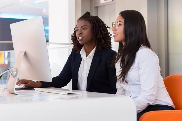 Female office colleagues working on project together