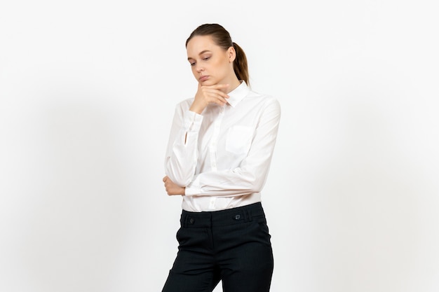 female office employee in elegant white blouse with thinking face on white