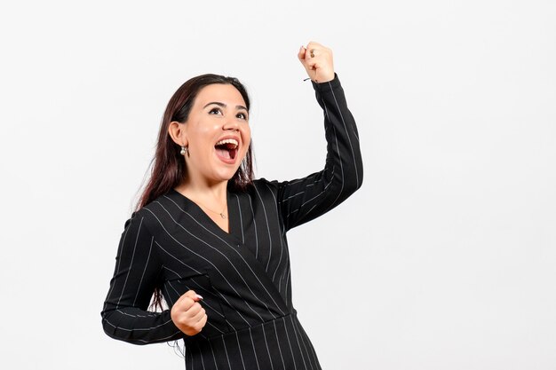 female office employee in strict black suit emotionally rejoicing on white