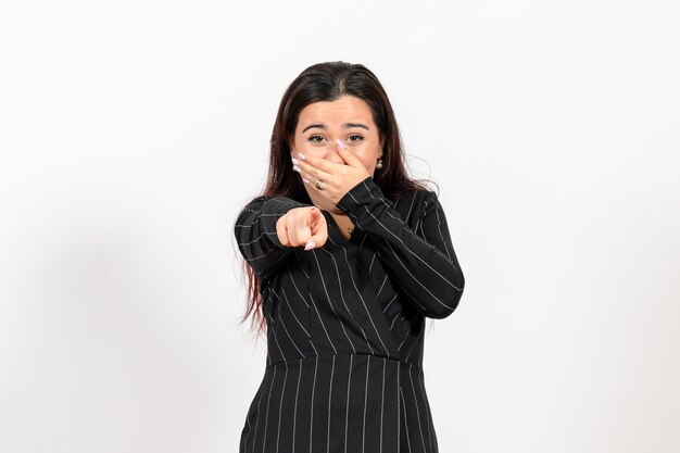 female office employee in strict black suit laughing on white