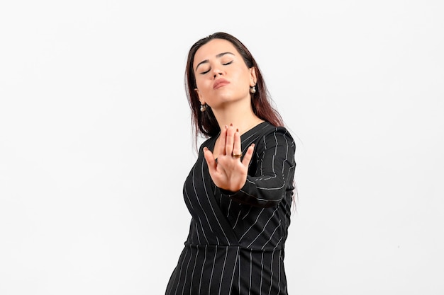 female office employee in strict black suit posing on white