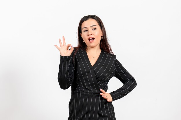 female office employee in strict black suit posing on white