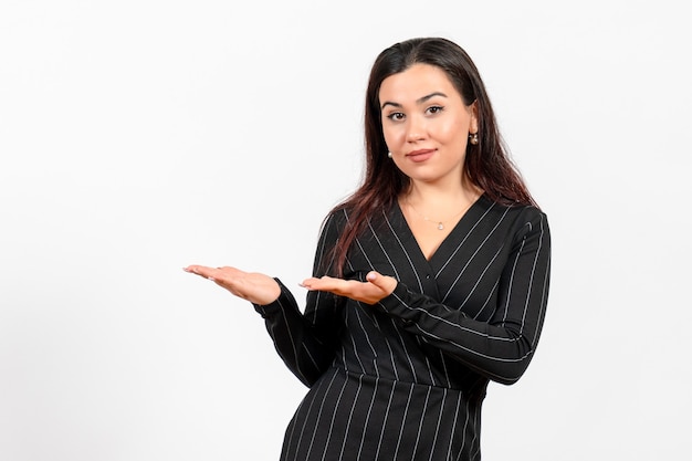 female office employee in strict black suit posing on white