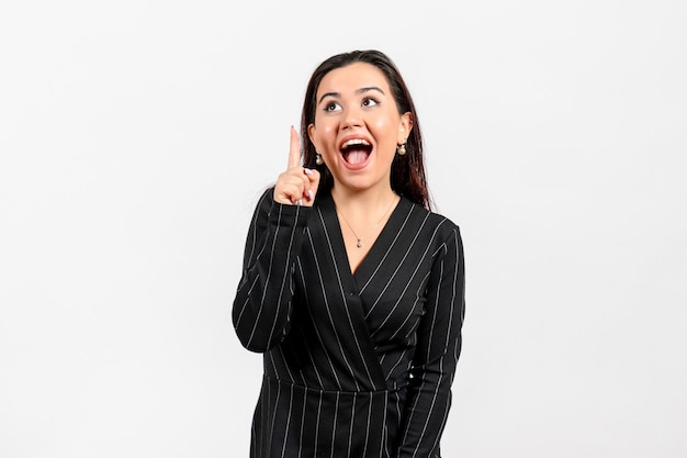 female office employee in strict black suit posing on white