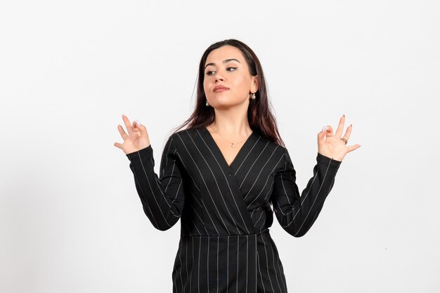 female office employee in strict black suit posing on white