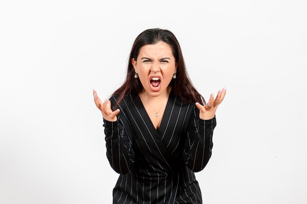 female office employee in strict black suit screaming on white