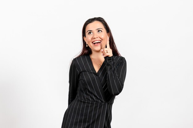 female office employee in strict black suit smiling on white