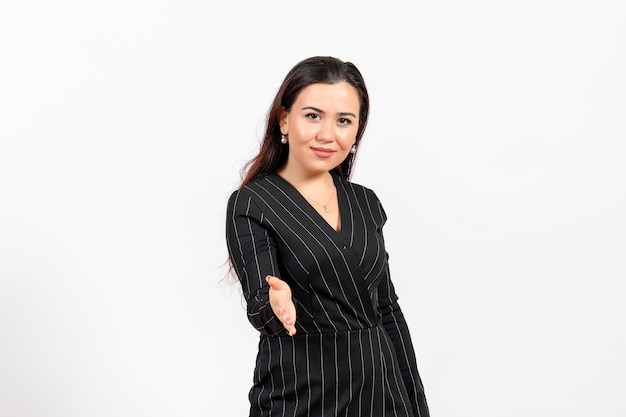 female office employee in strict black suit wanting to shake hands on white