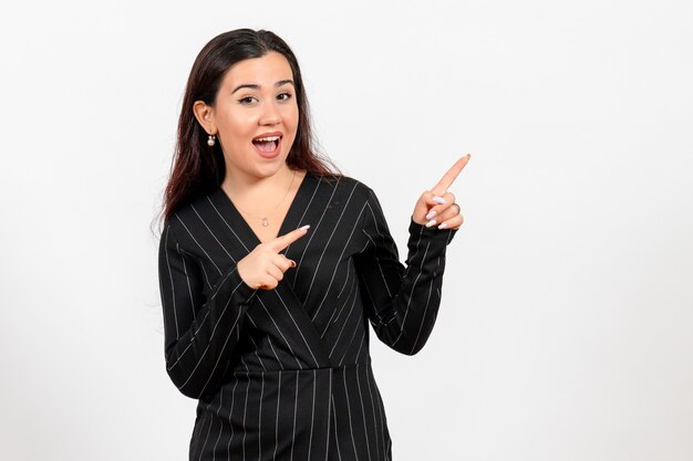 female office employee in strict black suit with funny face on white