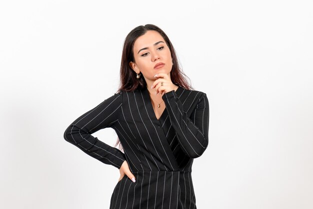 female office employee in strict black suit with thinking face on white