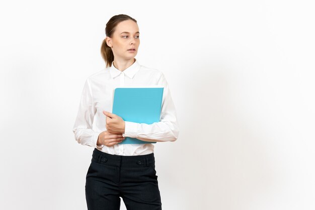 female office employee in white blouse holding blue file on white