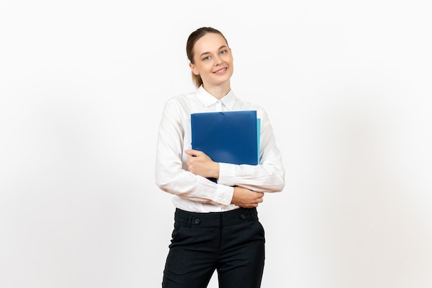 female office employee in white blouse holding documents on white