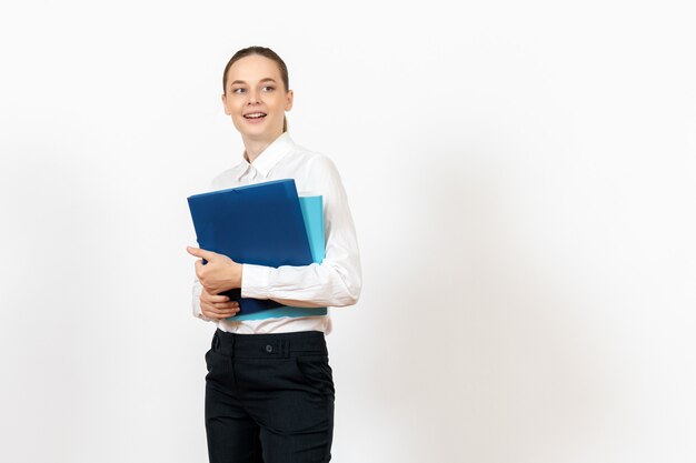 female office employee in white blouse holding documents on white