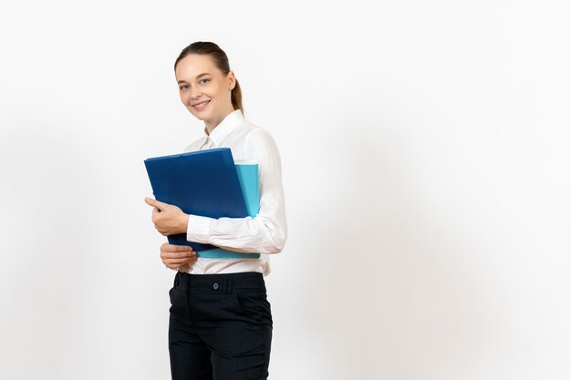 female office employee in white blouse holding documents on white