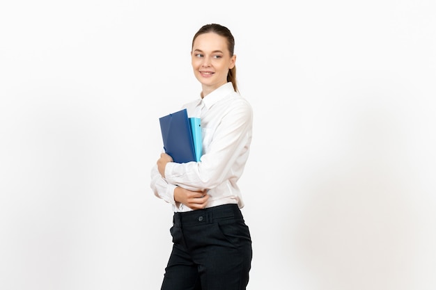 female office employee in white blouse holding documents with smile on white