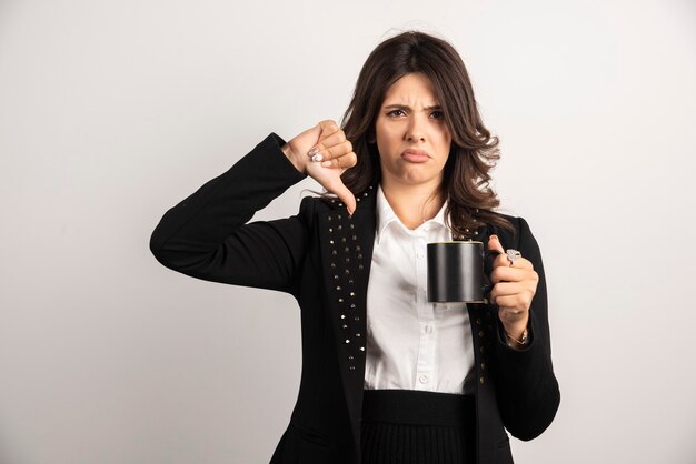 Female office worker giving thumbs down