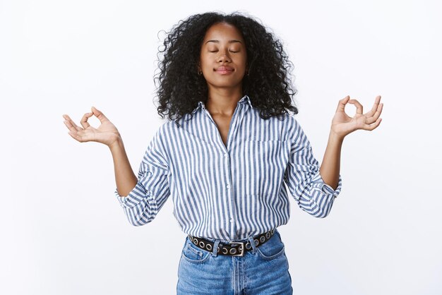 Female office worker meditating during lunch keep feelings emotions under control, do breathing practice yoga