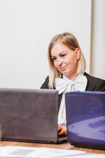 Female office worker using laptop