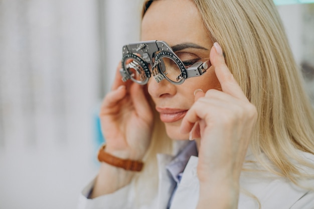 Female optician measuring her sight