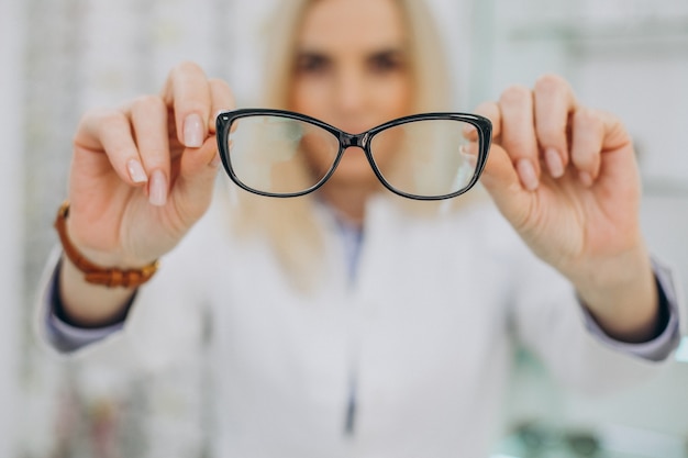 Female optician working at optic store