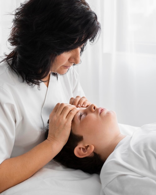 Female osteopathist treating a child at the hospital