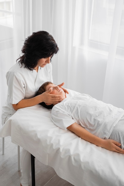 Female osteopathist treating a kid