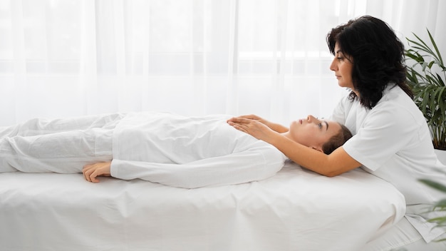 Female osteopathist treating a patient indoors