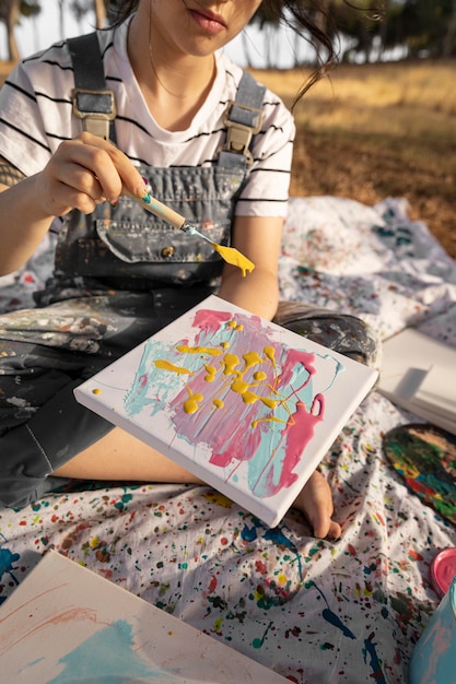 Female painter outdoors with canvas