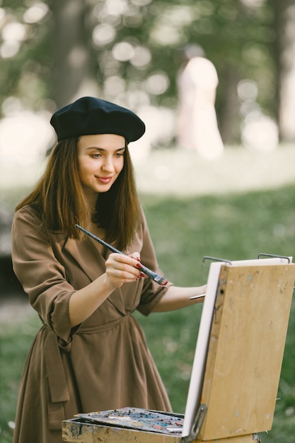 Female painter painting in the park