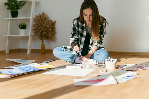 Female painter sitting on the floor